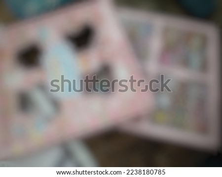 Defocused or blurred abstract background of a box of mini colorful stickers