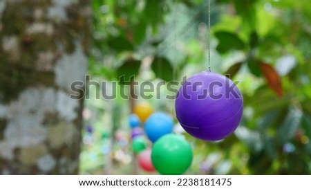 Many decorative balls hanging from tree branches