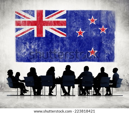 Silhouettes of Business People and a Flag of New Zealand 