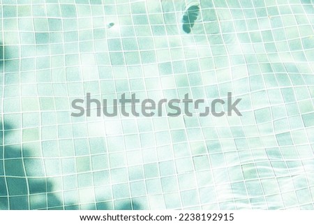 Water surface with waves on water surface  wave effect You can see the blue square tiles at the bottom of the pool.