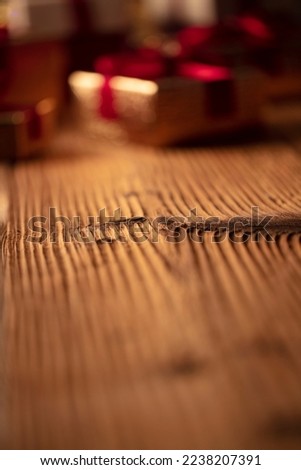 Shallow depth of focus. Colorful bokeh lights, rustic wooden table. Place for typography. Christmas background.