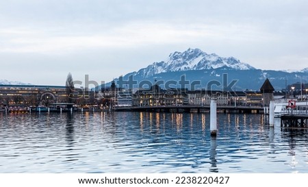 Panoramic view of the urban center of the city of Lucerne on Lake Lucerne (Vierwaldstattersee), Switzerland. Dusk over the city of Lucerne with the Alps mountains in the background.