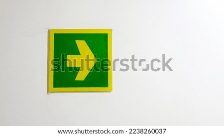 Green yellow right arrow acrylic sign in white background. Go to the right. 