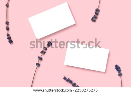 Mockup two cutaway, discount, business card on a pink minimalism background and lavender flowers with copy space. Template for design