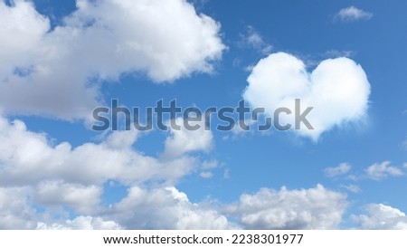 on the blue sky a cloud in the shape of a heart. horizontal frame. High quality photo