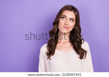 Photo of young positive attractive gorgeous woman wear white jumper pouted lips look empty space unsure choice isolated on violet color background