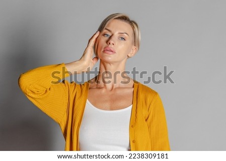 Portrait beautiful woman of model appearance. Girl in yellow jumper. Studio photography. High quality photo