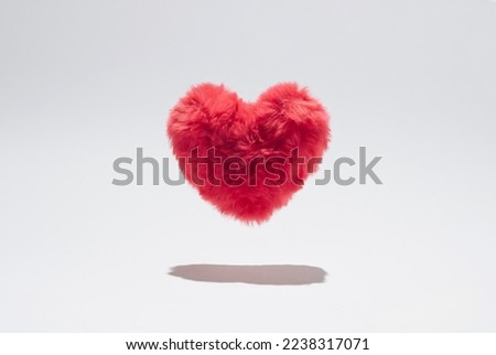 Pink fluffy plush heart levitating above white background. Royalty-Free Stock Photo #2238317071