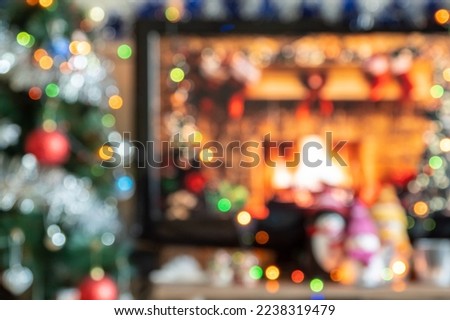 Abstract texture, yellow red green orange blue bokeh background. Blurred cozy celebration home scene with shining lights. Warm holiday feeling at fireplace and colorful toys on Christmas tree. Winter.