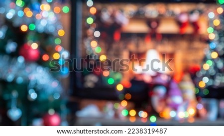 Abstract texture, yellow red green orange blue bokeh background. Blurred cozy celebration home scene with shining lights. Warm holiday feeling at fireplace and colorful toys on Christmas tree. Winter.