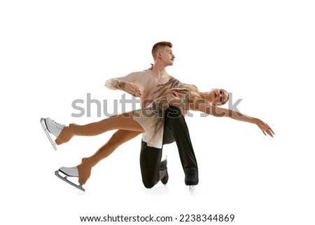 Young man and woman, figure skating athletes performing, dancing on stage costumes isolated on white studio background. Concept of movement, sport, beauty, hobby, competition, dance, choreography. Ad