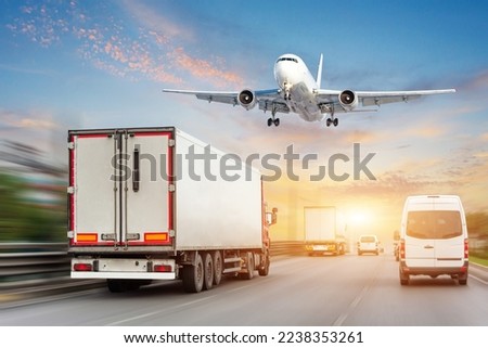 Heavy traffic flow of car traffic on freeway urban environment time, motion speed blur effect. Trailer trucks minibuses other vehicles drive on road landing plane to land at airfield terminal Royalty-Free Stock Photo #2238353261
