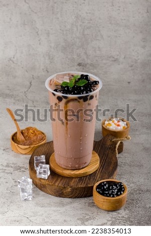 Boba or tapioca pearls is taiwan bubble milk tea in plastic cup with chocolate mint flavor on texture  background, summers refreshment. Royalty-Free Stock Photo #2238354013