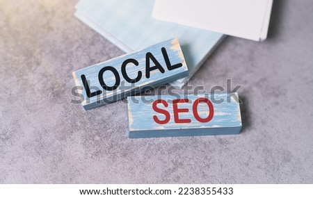 LOCAL SEO text on wooden block with notebook, business concept