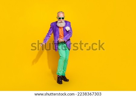 Full length photo of handsome funny man wear purple velvet jacket dancing discotheque isolated yellow color background