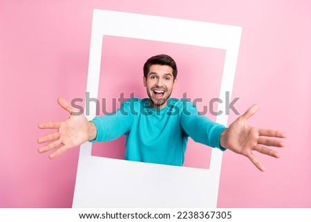 Photo portrait of attractive young man polaroid instant photo frame ready hug dressed stylish blue outfit isolated on pink color background