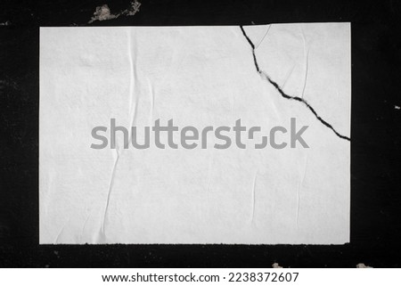 Torn paper with a crack on a black background.