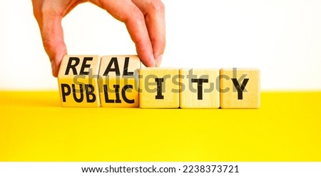 Reality or publicity symbol. Businessman turns wooden cubes and changes the word Publicity to Reality. Beautiful yellow table white background. Business reality or publicity concept. Copy space.