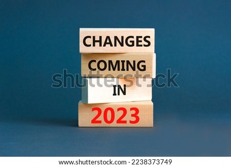 Changes coming in 2023 symbol. Concept word Changes coming in 2023 on wooden blocks. Beautiful grey table grey background. Business and changes coming in 2023 concept. Copy space.