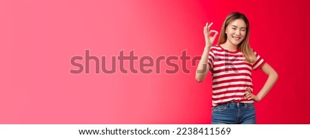 Good job mate. Proud happy female coworker approve your effort show okay gesture winking joyfully congratulate friend excellent plan, say well done make ok good approval gesture, red background.