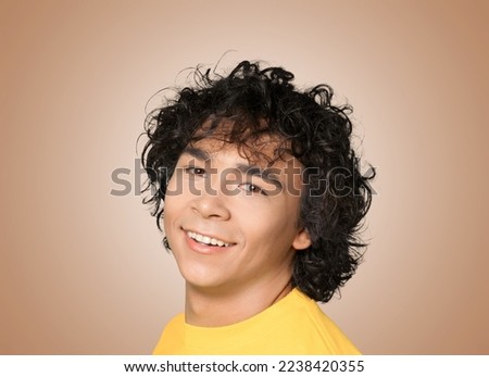 Positive young male posing on background