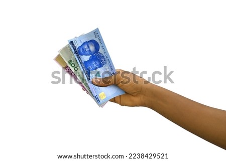Fair hand holding new 3D rendered Nigerian Naira notes isolated on white background Royalty-Free Stock Photo #2238429521
