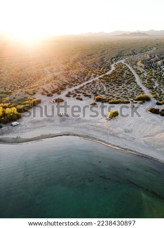 aerial view drone shot of lake mohave in the national recreation area of lake mead in nevada and arizona with the sun setting showing six mile cove and its sand
