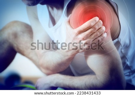 Detail of a representation of pain in the shoulder with red color on a bluish image. Front view. Royalty-Free Stock Photo #2238431433