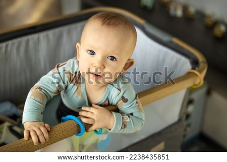 The gaze of an inquisitive child clinging to the crib Royalty-Free Stock Photo #2238435851