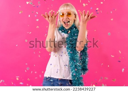 Confetti fashion party with sunglasses, blonde caucasian girl on pink background studio