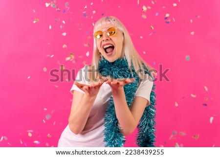 Confetti fashion party with sunglasses, blonde caucasian girl on pink background studio