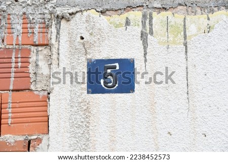House number 5, five blue metal plate address sign
