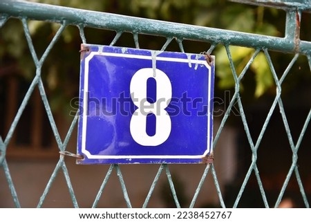House number 8, eight blue metal plate address sign 