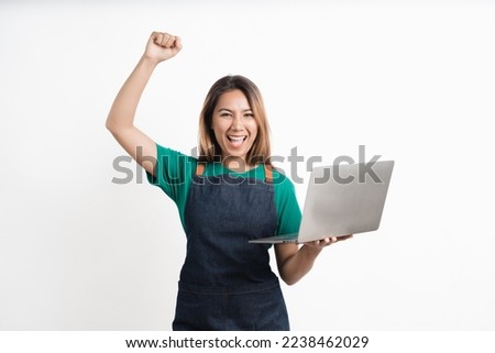 Young Asian business owners are excited by the good news while playing on computer laptop isolate on white background.