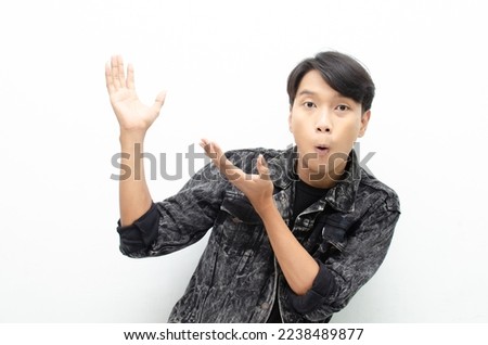 Young asian man open arms and hands palm to present something. proud Asian man with a smile offers and presents an advertisement