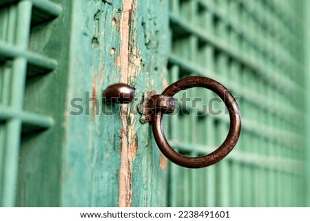 Rusty Doorknob on Green Door with Traditional Korean Patterns