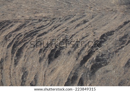 Black rough stone with sand texture closeup horizontal background from khong river, thailand