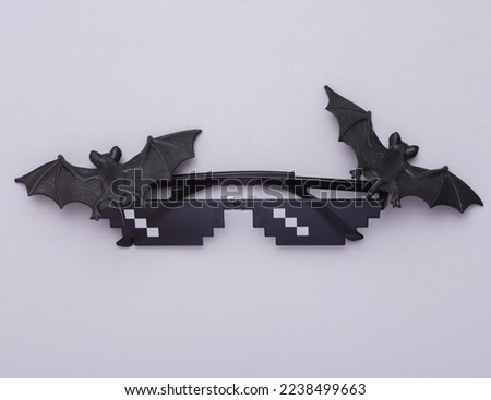 Pixel sunglasses with bats on a gray background. Halloween concept