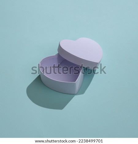 Empty white box in shape of heart on blue background