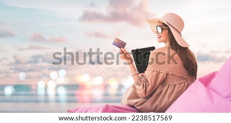 Portrait of happy smile young adult asian woman hand using credit card for cashless payment online for shopping or travel. Beach with sky banner background with copy space. Royalty-Free Stock Photo #2238517569