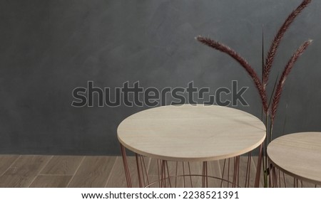minimal table and empty top wood on floor and gray loft wall space background, product presentation and home furniture construction concept