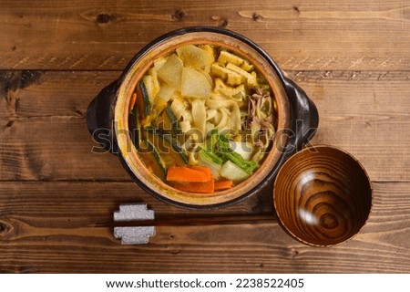A dish of thick, wide noodles simmered in miso broth with vegetables. Houtou