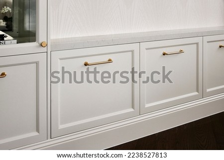 Photography detail of shaker style cupboard joinery doors and brushed gold handles. Royalty-Free Stock Photo #2238527813