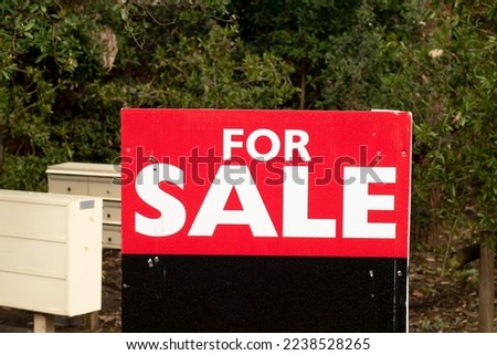 For sale sign on black board near the resedential building. Property Real estate bying selling investment concept