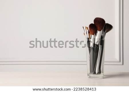 Set of professional makeup brushes on table against white background, space for text Royalty-Free Stock Photo #2238528413