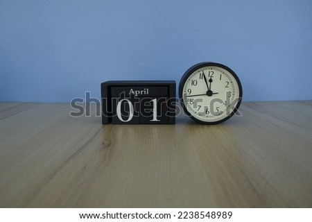 calendar with alarm clock on the table. April 1
