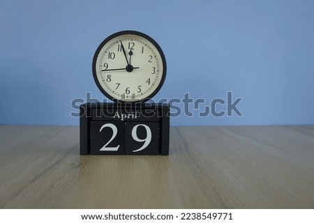 calendar cube with alarm clock on the table