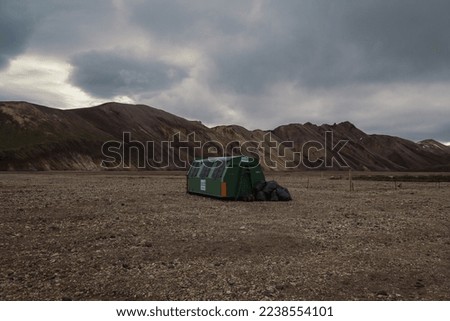 Trash bin at highland camp landscape photo. Beautiful nature scenery photography with mountains on background. Idyllic scene. High quality picture for wallpaper, travel blog, magazine, article