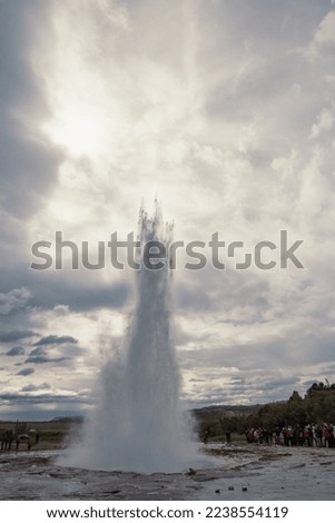 Thermal geyser eruption landscape photo. Beautiful nature scenery photography with cloudy sky on background. Idyllic scene. High quality picture for wallpaper, travel blog, magazine, article