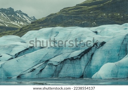 Huge glacier on sea coast landscape photo. Beautiful nature scenery photography with old mountains on background. Idyllic scene. High quality picture for wallpaper, travel blog, magazine, article